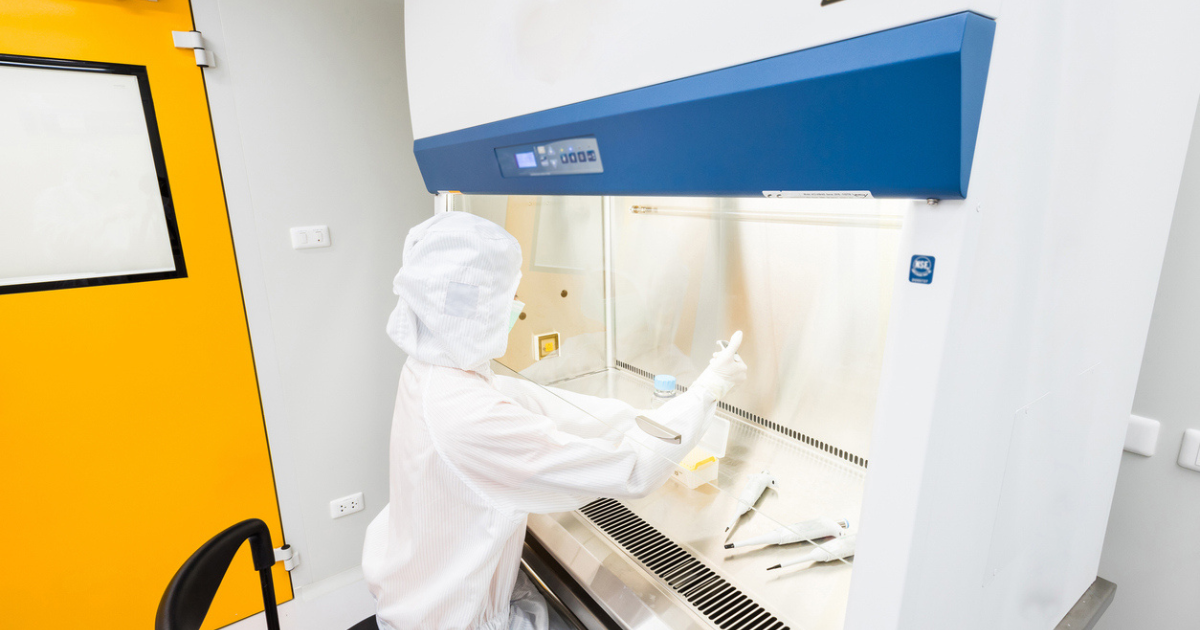 A scientist working under a fume hood for BHO extration.